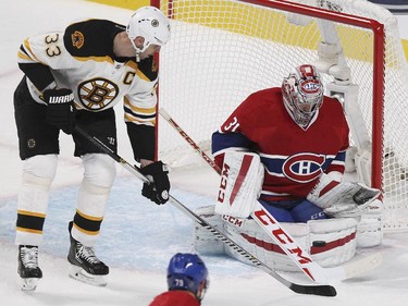 Montreal Canadiens goalie Carey Price makes a save as Boston Bruins Zdeno Chara looks for rebound during National Hockey League game in Montreal Thursday October 16, 2014.  Habs Andrei Markov is at bottom of frame.