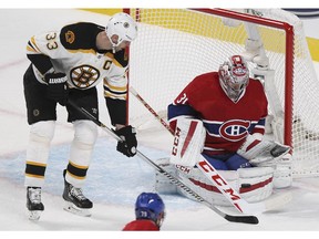 Montreal Canadiens goalie Carey Price makes a save as Boston Bruins Zdeno Chara looks for rebound during National Hockey League game in Montreal Thursday October 16, 2014.  Habs Andrei Markov is at bottom of frame.