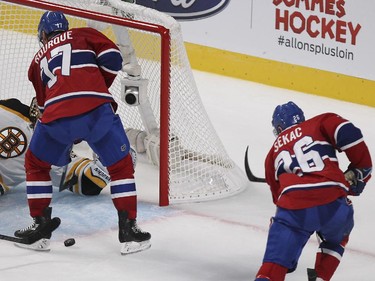 Montreal Canadiens Jiri Sekac scores the first goal of his career against Boston Bruins goalie Tuukka Rask as team-mate Rene Bourque provides the screen during National Hockey League game in Montreal Thursday October 16, 2014.