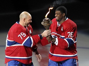 P.K. Subban passes the torch to Andrei Markov during ceremony before the Canadiens' NHL home opener at the Bell Centre on Oct. 16, 2014.