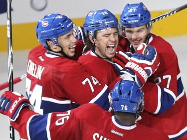 Montreal Canadiens Pierre-Alexandre Parenteau, centre, celebrates his second period goal against the Boston Bruins with team-mates Alexei Emelin, left, Alex Galchenyuk, right, and P.K. Subban during National Hockey League game in Montreal Thursday October 16, 2014.