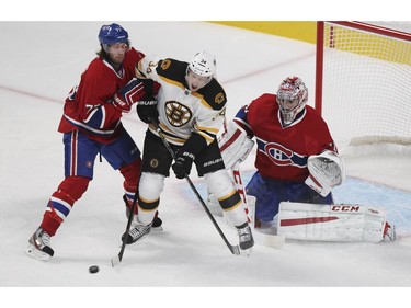 Montreal Canadiens Tom Gilbert, left, clears Boston Bruins Carl Soderberg from in front of goalie Carey Price during National Hockey League game in Montreal Thurssday October 16, 2014.