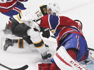 The puck bounces off Boston Bruins Simon Gagne's skate past Montreal Canadiens goalie Carey Price for a goal during third period of National Hockey League game in Montreal Thursday October 16, 2014.