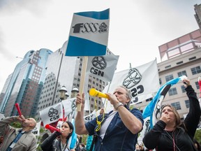 People protesting against cuts to the healthcare system gather outside the office of Quebec Premier Philippe Couillard in Montreal on Friday, October 17, 2014. Protesters were denouncing the Couillard government's austerity policies.