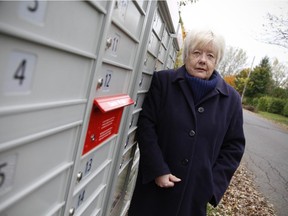 Donna Long must now use a community mailbox as home delivery service from Canada Post has been cut in certain neighbourhoods, such as Rosemere, where Long lives, north of Montreal Monday October 20, 2014.