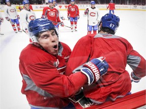The Canadiens' Brendan Gallagher, bounces off a check by teammate Max Pacioretty during practice drill at the Bell Centre on Oct. 20, 2014.