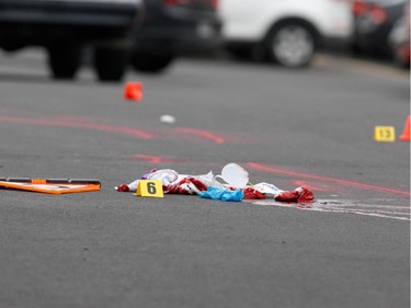 Surete du Quebec police and Saint-Jean-sur-Richelieu police investigators, not seen, go over the scene of a hit and run in Saint-Jean-sur-Richelieu near Montreal on Monday October 20, 2014.  A motorist ran over 2 pedestrians and fled the scene, when confronted by police, he is alleged to have charged them with a knife and was shot dead by police. (Allen McInnis / THE GAZETTE)