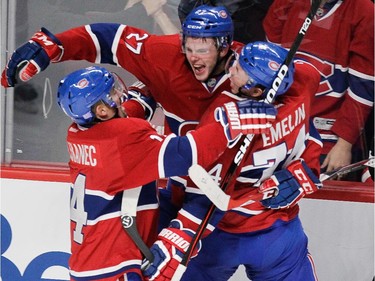 Alex Galchenyuk (#27) of the Montreal Canadiens celebrates his game-tying goal with teammates Tomas Plekanec (left) and Alexei Emelin in the third period against the Detroit Red Wings in NHL action at the Bell Centre in Montreal on Tuesday, October 21, 2014.
