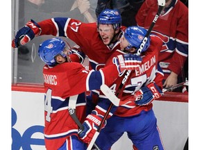 MONTREAL, QUE.: OCTOBER 21, 2014 -- Alex Galchenyuk (#27) of the Montreal Canadiens celebrates his game-tying goal with teammates Tomas Plekanec (left) and Alexei Emelin in the third period against the Detroit Red Wings in NHL action at the Bell Centre in Montreal on Tuesday, October 21, 2014 .(John Kenney / MONTREAL GAZETTE)