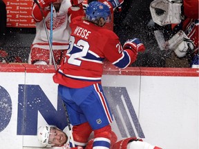 Dale Weise of the Montreal Canadiens checks Brendan Smith of the Detroit Red Wings in Montreal, on Tuesday, October 21, 2014 in NHL action at the Bell Centre.