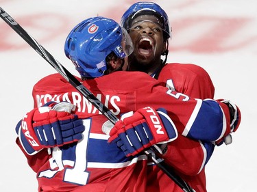 David Desharnais (left) and P.K. Subban of the Montreal Canadiens celebrate Desharnais's overtime-winning goal against the Detroit Red Wings  in NHL action at the Bell Centre in Montreal on Tuesday, October 21, 2014.