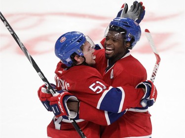 David Desharnais (left) of the Montreal Canadiens celebrates his overtime-winning goal against the Detroit Red Wings in NHL action at the Bell Centre in Montreal on Tuesday, October 21, 2014, with teammate P.K. Subban.