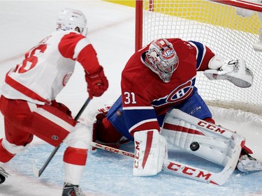 Goalie Carey Price of the Montreal Canadiens stops Tomas Jurco of the Detroit Red Wings in Montreal, on Tuesday, October 21, 2014 in NHL action at the Bell Centre.