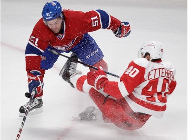 Goalie David Desharnais  of the Montreal Canadiens knocks over Henrik Zetterberg of the Detroit Red Wings in the first period in NHL action at the Bell Centre in Montreal on Tuesday, October 21, 2014.