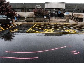 Markings on strip mall pavement in St-Jean-sur-Richelieu on Tuesday, indicate where Martin Couture Rouleau, 25, mowed down military members outside a Services Canada/SAAQ building.
