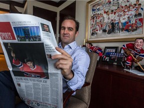 Canadiens owner, president and CEO  Geoff Molson reads the sports section of the newly launched redesign of the Montreal Gazette in his office at the Bell Centre on Oct. 21, 2014