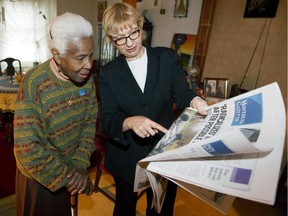 Montreal Gazette editor-in-chief Lucinda Chodan, right, describes the layout of the re-designed Gazette to longtime subscriber Colleen Dick at Dick's home in Montreal, Oct. 21, 2014. It is also Dick's birthday.