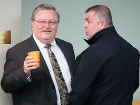 Nasser Mahmoud Aoude, right, speaks to his lawyer Richard Brouillard, left, as he waits for his sentencing hearing at the Laval Courthouse on Tuesday, October 21, 2014.