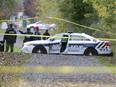 Police cordon off a bike path next to Chemin de Chambly in Longueuil Oct. 22, 2014, where a woman was found beaten and unconscious. She died in hospital.