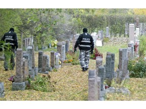 Longueil police search a cemetery next to a cycling path at Chemin de Chambly near Guillaume Street in Longueil south of Montreal, Wednesday, October 22, 2014, where a woman was found beaten and unconscious.  She died in hospital.
