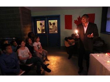 Abdoulaye Diallo, who was the chief of civilian staff for the United Nations in Rwanda during the 1994 genocide, speaks to young people at candlelight vigil was held for Warrant Officer Patrice Vincent, who was killed in St-Jean-sur-Richelieu on Monday, and Cpl. Nathan Cirillo, who was shot in Ottawa on Wednesday, and their families.