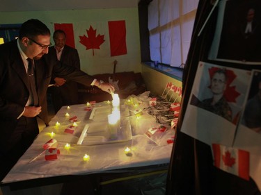 Bill Korbatly lights a candle.