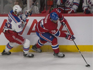 Montreal Canadiens P.K. Subban outskates  New York Rangers Anthony Duclair  to hold onto the puck during 1st period NHL action in Montreal  on Saturday, October 25, 2014.