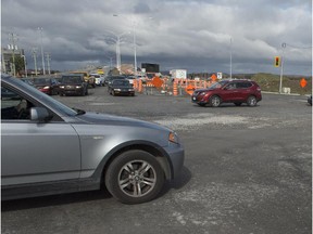 MONTREAL, QUE.: OCTOBER 26, 2014 -- Cars navigate the Corner of St-Charles Ave. and Cite des Jeunes Blvd. the muddy mess that is the major intersection in Vaudreuil, which has been under construction for weeks. Sunday, October 26, 2014. (Peter McCabe / MONTREAL GAZETTE)