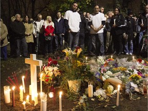 John Gandolfo, centre right, father of Jenique Dalcourt, and Nick Gandolfo, left centre, Jenique's brother, stand next to memorial for her on Tuesday, Oct. 28, 2014.