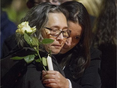 Monique Dalcourt, left, mother of Jenique, receives a hug during memorial for Jenique Dalcourt on Tuesday October 28, 2014. The 23-year-old woman was killed was last week in Longueuil while riding her bike.