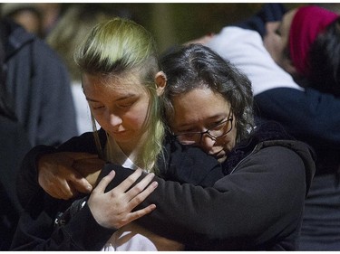 Monique Dalcourt, right, mother of Jenique, gives a hug during memorial for Jenique Dalcourt on Tuesday October 28, 2014. The 23-year-old woman was killed last week in Longueuil while riding her bike.