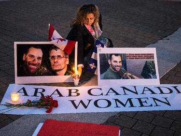 Nahed Alshawa, originally from Palestine, lights candles during a vigil organized by Arab-Canadian women to honour slain soldiers Corporal Nathan Cirillo and Warrant Officer Patrice Vincent at Place des Arts in Montreal on Tuesday, Oct. 28, 2014.