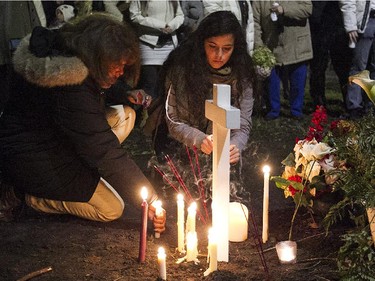 People lay flowers next to the memorial for Jenique Dalcourt on Tuesday October 28, 2014. The 23-year-old woman was killed last week in Longueuil while riding her bike.