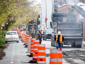 Construction crews prepare a section of de Maisonneuve Blvd. for repaving on Wednesday, Oct. 29, 2014.