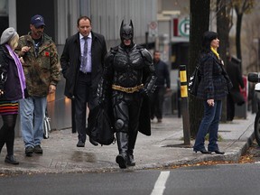 Pablo Rinaldis dressed as Batman  crossing the street at the corner of René-Levesque and University in Montreal on Halloween in 2012.