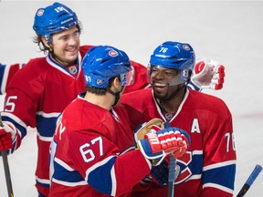 Montreal Canadiens left wing Max Pacioretty, front left, celebrates his goal with Montreal Canadiens defenceman P.K. Subban, front right, along with teammate P.A. Parenteau, rear, during the first period of their preseason NHL hockey match against the Ottawa Senators at the Bell Centre in Montreal on Saturday, October 4, 2014.