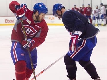 Forward Brandon Prust (left) of the Montreal Canadiens gets around defenceman Andrei Markov at the Bell Sports Complex in Brossard near Montreal, on Tuesday, October 7, 2014 before the NHL season opener against the Toronto Maple Leafs Wednesday.