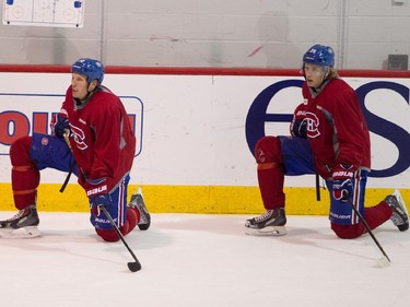 At left Travis Moen and Jacob de la Rose watch teammates at practice at the Bell Sports Complex in Brossard near Montreal, on Tuesday, October 7, 2014. de la Rose was the last cut on the team before the NHL season opener against the Toronto Maple Leafs Wednesday.