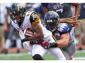 MONTREAL, QUE.: SEPTEMBER 07, 2014 -- Montreal Alouettes Bear Woods tackles Hamilton Tiger Cats Bakari Grant during first half of Canadian Football League game in Montreal Sunday September 07, 2014.  (John Mahoney  / THE GAZETTE) ORG XMIT: 50842-0572
