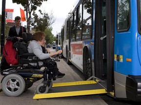 A woman boards a bus with technology to improve wheelchair accessibility, at the Lionel-Groulx métro stop in Montreal, on Sept. 14, 2009.