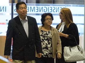 Sy Veng Chun and Leng Ky Leck, a couple accused of money laundering, along with their legal team make their way to the courtroom in Montreal, Monday September 15, 2014.