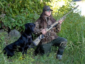 Fourteen-year-old Laval student Stella Panitsas with her retriever, Champ, north of Montreal Wednesday September 24, 2014. Stella got her hunting license two years ago and hunts waterfowl with her father and brother.