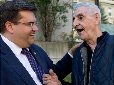 Sept. 25, 2014: After meeting with members of the media during a press conference about the city's homeless, Mayor Denis Coderre speaks with René Lallemand,a client of the Maison du Père homeless shelter.