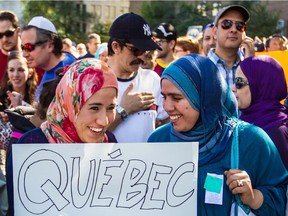 Women wearing hijabs take part in a protest rally against the PQ's proposed Charter of Quebec Values in Montreal on Sept. 29, 2013.