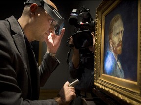 Allen Kosanovich, associate paintings conservator  with the Wadsworth Atheneum Museum of Art, examines a Vincent van Gogh self-portrait at the Montreal Museum of Fine Arts in Montreal on Tuesday, Sept. 30, 2014.