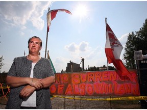 Paula Sherman stands at the blockaded gate, one entry point to the disputed land in July 2007. A land dispute between the Ardoch Algonquin First Nations and an uranium mining company (Frontenac Ventures) reached a boiling point  after Algonquin representatives were served with a $77-million lawsuit.