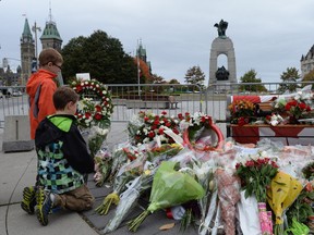 Canada has its work cut out trying to understand the root causes for this week's terror attacks in St.Jean-sur-Richelieu and Ottawa. On Thursday, two children lay floral tributes to slain Cpl. Nathan Cirillo at the National War Memorial in Ottawa.