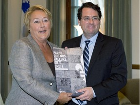 In this file picture from September of 2013, then Quebec Premier Pauline Marois receives the Charter of Quebec Values from Bernard Drainville,  then Minister Responsible for Democratic Institutions and Active Citizenship. Now a candidate for the PQ leadership, Drainville says he would re-introduce a new version of the charter if elected.