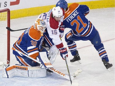 Montreal Canadiens' Pierre-Alexandre Parenteau and Edmonton Oilers' Andrew Ference battle in front of goalie Ben Scrivens during second-period action in Edmonton on Monday, Oct. 27, 2014.