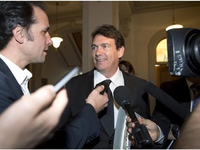 Quebec Opposition MNA Pierre-Karl Peladeau smiles while being questioned by reporters as he enters a caucus meeting, Tuesday, Oct. 28, 2014, at the legislature in Quebec City.